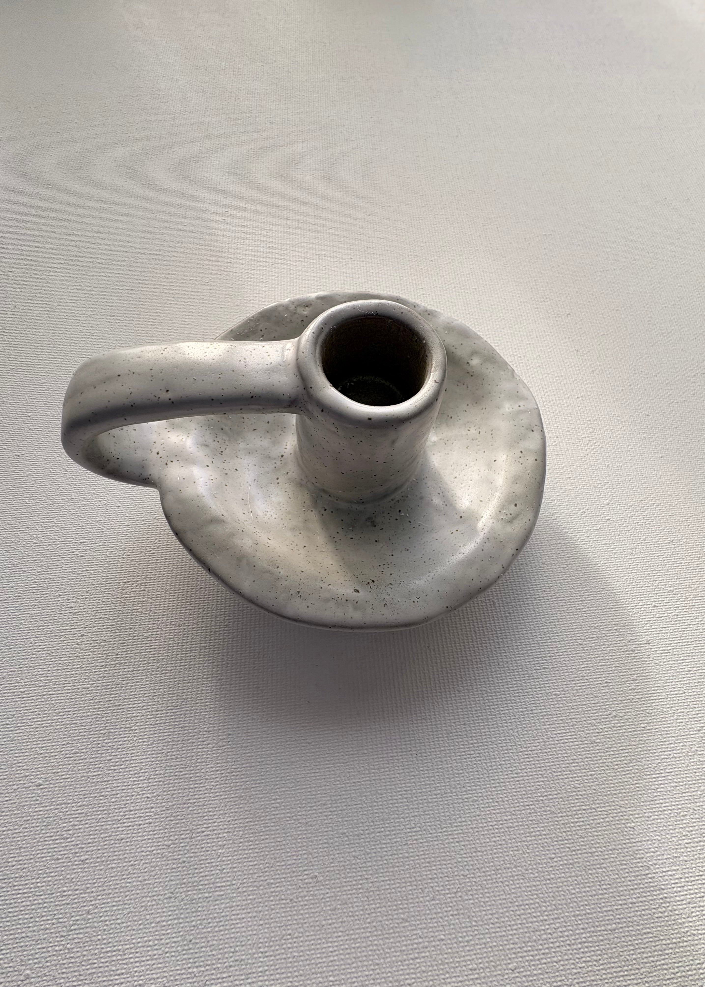 Ceramic candle holder on a light gray background